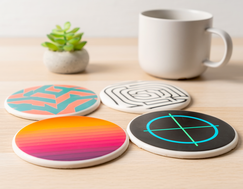 Four colorful coasters on a wooden surface 