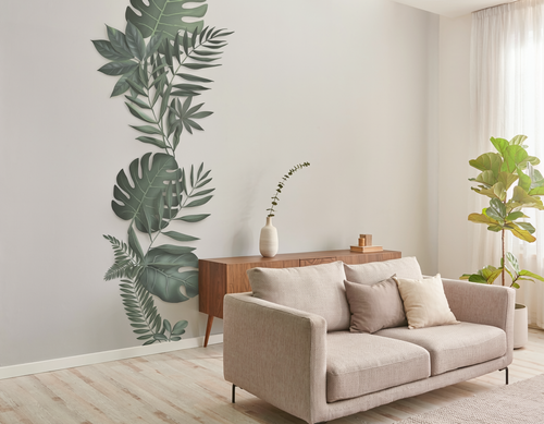 Living room with a graphic of leaves on the wall